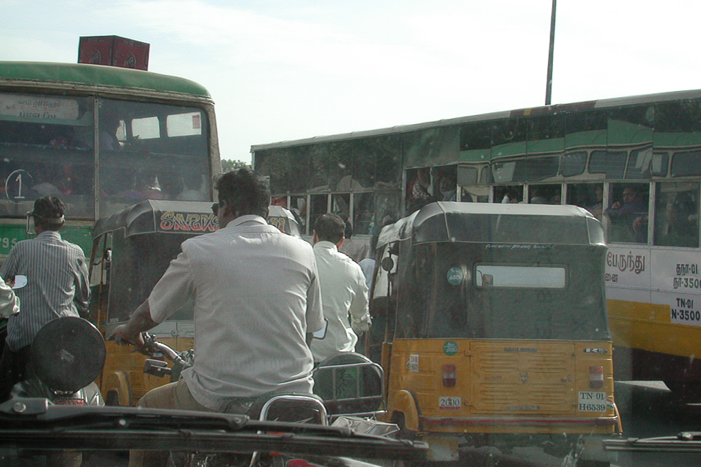 Bus, rickshaw et deux-roues occupent toute la chaussée.
