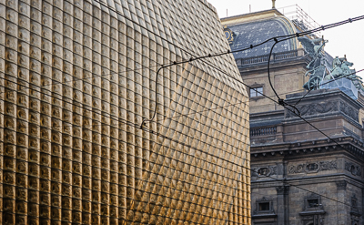 Façade contemporaine en pavés de verre devant un bâtiment historique de Prague