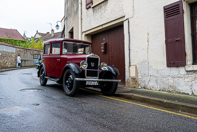 Ancienne voiture bordeaux à carrosserie utilitaire devant une maison d’Épône